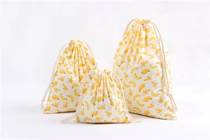 Three-piece set of drawstring cotton storage bags with yellow banana pattern print