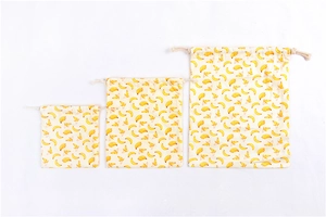 Three-piece set of drawstring cotton storage bags with vibrant yellow banana prints