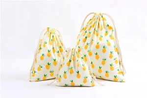 Three assorted sizes of cotton linen drawstring bags with yellow pineapple print