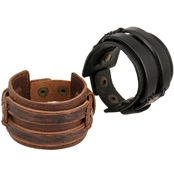 Detail view of vintage multi-layer leather bracelets in black and brown with metal buckles