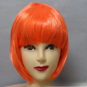 Detail view of a bright orange synthetic bob wig with neat bangs on a mannequin head