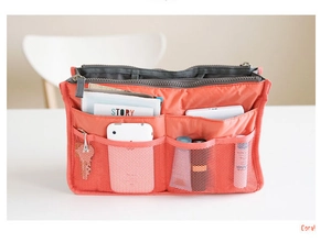 Detail of coral nylon handbag organizer showing multi-pocket structure and mesh compartments