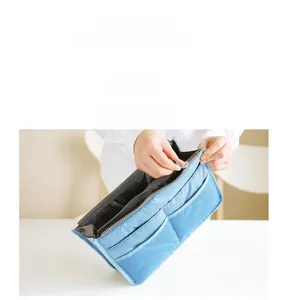 Detailed view of light blue nylon bag organizer with dual zippers and external pockets