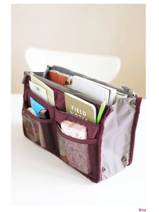 Detailed wine red organizer insert showing dual zipper compartments and mesh side pockets