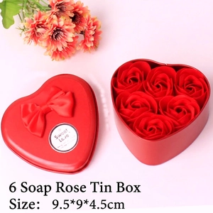 Detailed view of red heart-shaped tin box with six soap roses and silk bow decoration