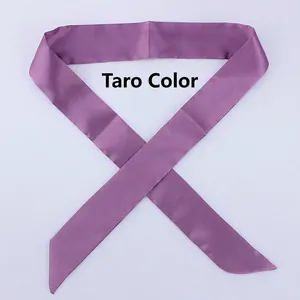 Close-up of mauve narrow satin scarf tied in a bow on a plain light grey background