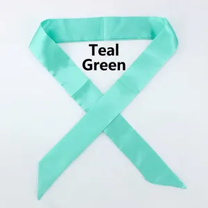 Close-up of mint green satin silk scarf with smooth texture and glossy finish