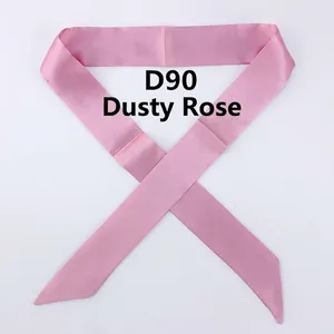 Detail of dusty pink satin skinny scarf with elegant pointed ends for handbag decor