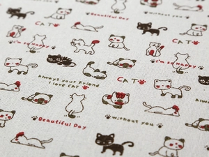 Detailed fabric texture of linen microwave cover with cute cat patterns and text