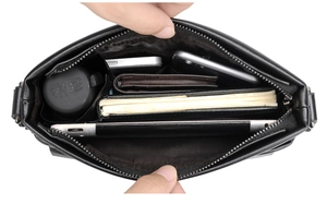 Top-down view of a spacious men's black shoulder bag interior with multiple compartments