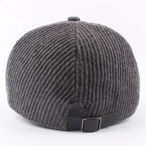Rear view of dark grey knitted newsboy cap with vertical stripes and leather strap