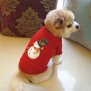 Detail of red pet T-shirt featuring a cartoon snowman print on a small Pomeranian dog