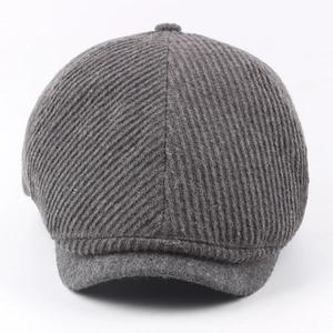 Thick knitted newsboy cap in charcoal grey with warm diagonal weave wool texture