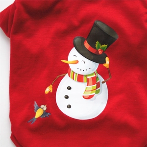 Detail of red Christmas dog shirt with snowman and winter bird print in cotton