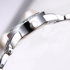 Side view of elegant silver ladies' watch with rhinestone bezel and metal band