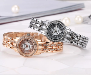 Macro view of rose gold and silver rhinestone-encrusted watches with shell dials