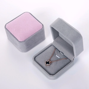 Macro shot of gray and pink velvet jewelry boxes showing soft texture for necklaces