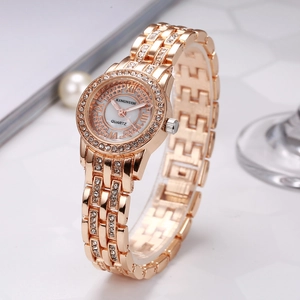 Detailed close-up of elegant ladies quartz watch with rhinestone bezel and shell dial texture
