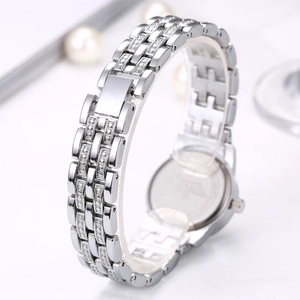 Elegant silver ladies watch featuring a sparkling rhinestone strap on a white surface