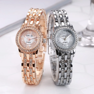 Detail of two luxury women's watches in gold and silver with rhinestone accents