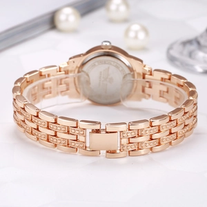 Detailed view of rose gold women's watch band with sparkling rhinestone accents.