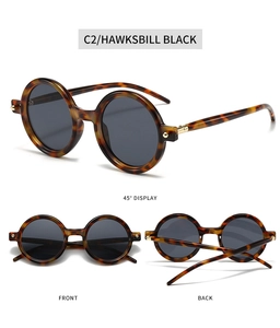 Detail view of retro round sunglasses in hawksbill black with gold rivet accents