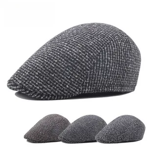 Detail view of newsboy caps in wool blend tweed texture and multiple vintage colors