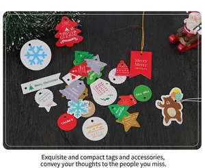 Flat lay of colorful Christmas paper gift tags with festive patterns on wood background