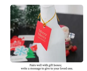Close-up of a festive red Christmas paper tag with golden string on a bottle neck