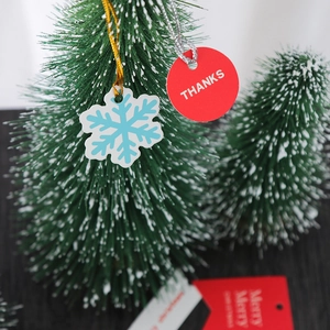 Christmas gift tags with snowflake and red THANKS design on a frosted holiday tree