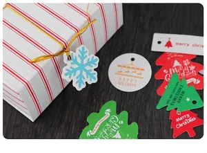 Detailed view of varied Christmas gift tags with snowflakes and trees on gift boxes