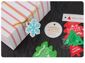 Detailed view of varied Christmas gift tags with snowflakes and trees on gift boxes