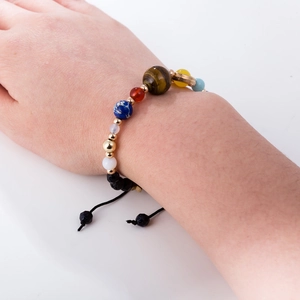 Solar system eight planets bracelet with natural stone beads on a female wrist