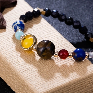 Detailed macro view of the Solar System bracelet with natural stone planetary beads
