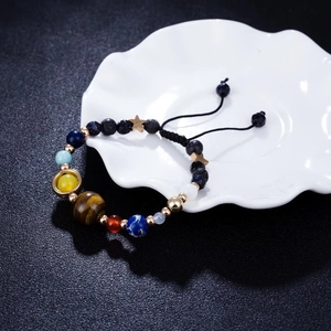 Macro view of solar system bead bracelet with natural stones and gold star charm