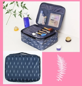 Macro view of blue leaf pattern and organized compartments in large capacity cosmetic bag