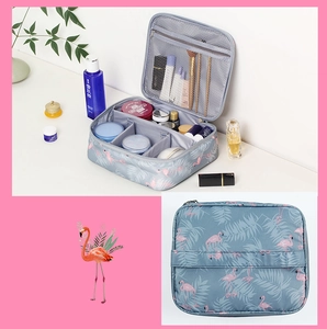 Detailed view of grey flamingo cosmetic bag showing open storage and closed waterproof texture