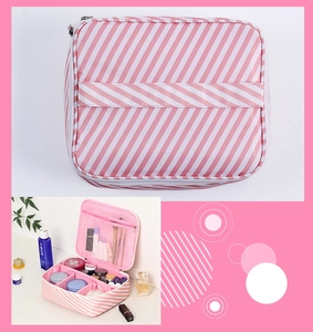 Detail view of large capacity makeup bag with striped design and mesh compartments