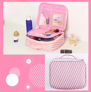 Pink and white striped cosmetic bag detail showing portable handle and mesh compartments