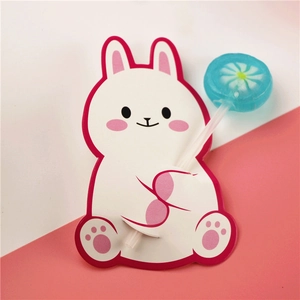 Close-up of cute white rabbit paper card holder for lollipop DIY Christmas decoration