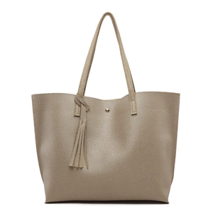 Close-up of litchi texture gold PU leather surface with decorative tassel details