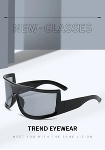 Detail of cyber Y2K wrap-around sunglasses with thick glossy black frames and grey lenses