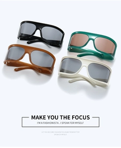 Flat lay of colorful oversized Y2K cyberpunk sunglasses with thick frames in four colors