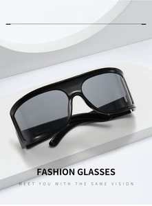 Close-up of sleek black Y2K futuristic wrap-around sunglasses on a white pedestal