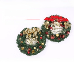 Detail of 30cm Christmas wreaths with red and gold bows, bells and Merry Christmas signs