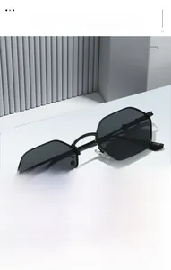 Detailed view of black polygonal sunglasses with modern bamboo-style temples on a white base