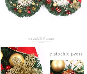 Macro detail of 30cm Christmas wreath with red ornaments and Merry Christmas plaque