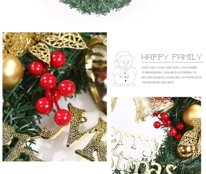 Close-up of a 30cm Christmas wreath featuring red berries, gold bells and Merry Christmas sign