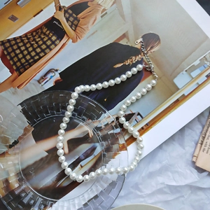 Detail of 925 sterling silver pearl necklace with adjustable clasp on a glass tray