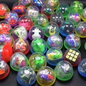 Close-up of mixed colorful 32-65mm transparent plastic toy capsules with mini prizes inside